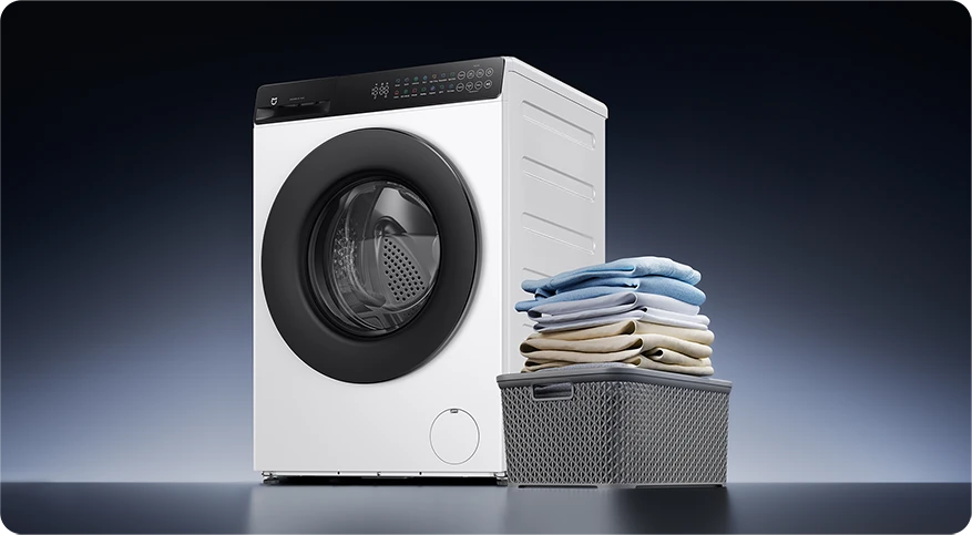 Mijia Front Load Washer 8kg obok kosza z poskładanym praniem